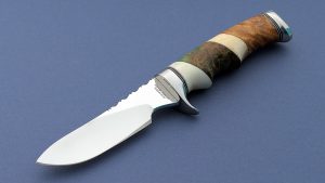 Ruffin Johnson Custom Vintage Hunting Knife Ruffin, El Lobo Solo The Lone Wolf was known for his unique handle configurations. He made knives for 40 years Handle is a combo of Ivory, Maple, Oosik & Snakewood Great handle ergonomics!