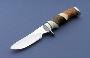 Ruffin Johnson Custom Vintage Hunting Knife Ruffin, El Lobo Solo The Lone Wolf was known for his unique handle configurations. He made knives for 40 years Handle is a combo of Ivory, Maple, Oosik & Snakewood Great handle ergonomics!