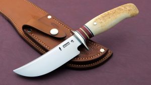 James Behring Sr. Custom made Hunting Knife Treeman Hunter with Artifact Ice Axe Fossil Walrus Ivory Scagel logo