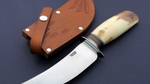 Jim Behring Jr. Skinner Custom made knife with Fossil Walrus Ivory handle and embossed leather sheath Add this to the Jim Behring Sr. Hunter for a excellent set. USA 2014 is marked in the back of the blade. Vintage Collectible!
